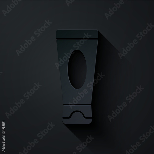 Paper cut Cream or lotion cosmetic tube icon isolated on black background. Body care products for men. Paper art style. Vector