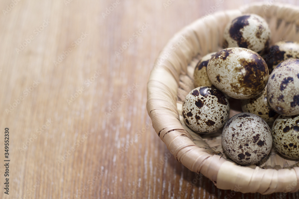 Fototapeta premium Quail eggs in a basket