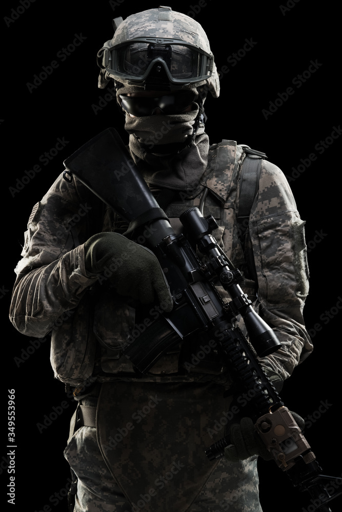 Male in US Army uniform soldier (Flag of the ISAF on the shoulder). Shot in studio. Isolated with clipping path on black background
