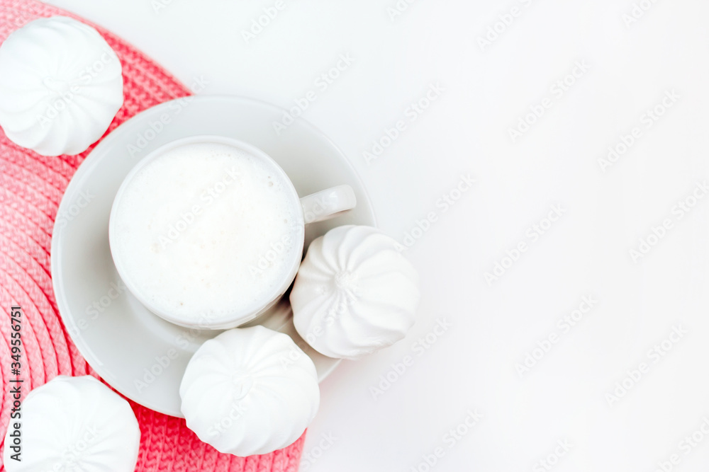 Cup of cappuccino and white zephyr on white and pink background. Top view with copy space Cup of cappuccino and white zephyr on white and pink background. Top view with copy space