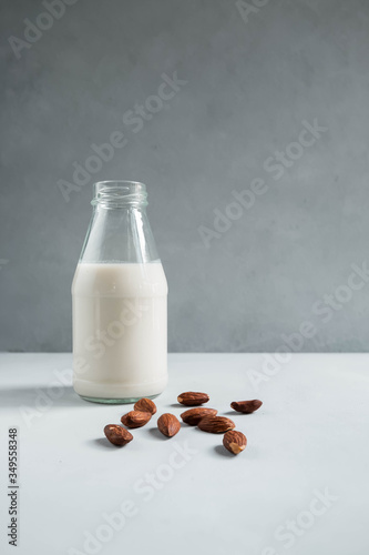 Fresh almond milk and almonds. Bottle of milk. Healthy vegetarian food and drink concept.