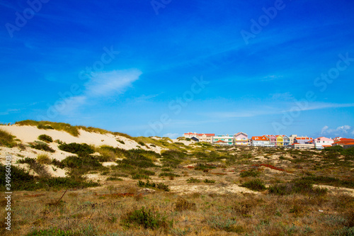 Costa Nova, Portugal: colorful striped beach houses called Palheiros next to Atlantic coast near Aveiro.