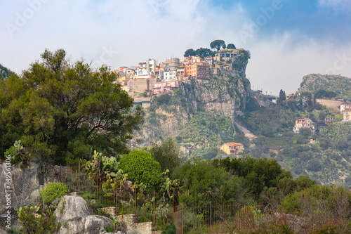 Mountain village Castelmola in the Italian region Sicily in sunny day as seen from Taormina, Italy