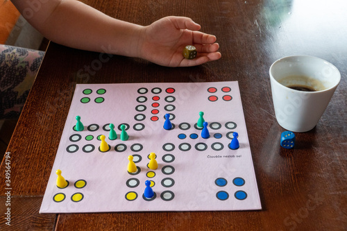 playing board ludo and coffee with girl's hand