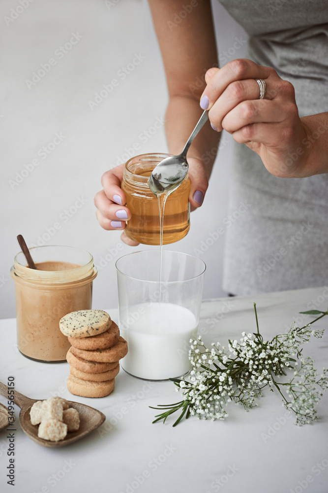Pouring honey to milk - obrazy, fototapety, plakaty 