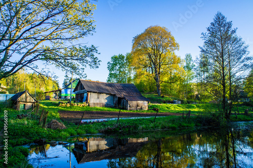 Old village house near lake and forest