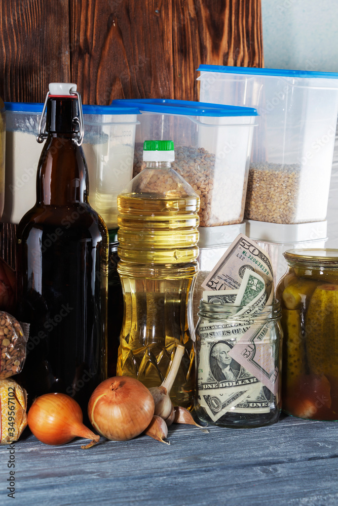 glass jar with paper dollars. against the background of products. Keeping the money. Investment. glass jar with paper dollars. against the background of products. Keeping the money. Investment.