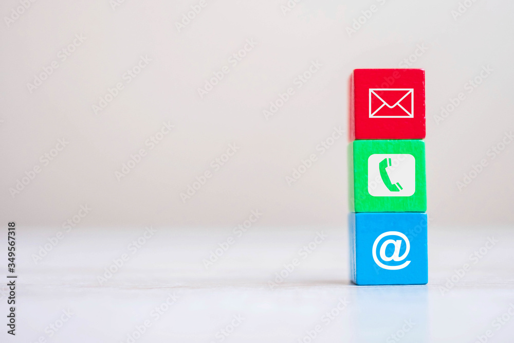 cube block with email, telephone and address website symbol on table background. contact, marketing and information concept cube block with email, telephone and address website symbol on table background. contact, marketing and information concept