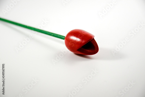 Still life with a red wooden tulip with a white background