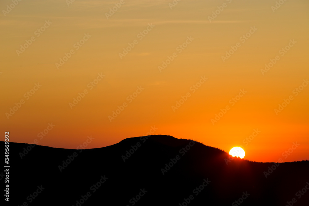 Sunrise in the clear cloudless sky on the mountain. Summer sunrise in the mountains