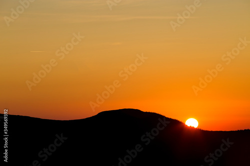 Sunrise in the clear cloudless sky on the mountain. Summer sunrise in the mountains