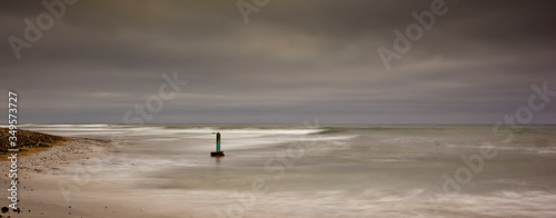 long exposure image of rocks,sea, clouds