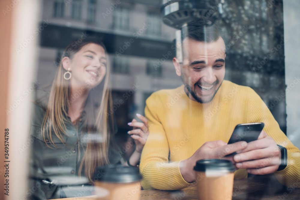 Funny couple laughing on joke on phone Funny couple laughing on joke on phone
