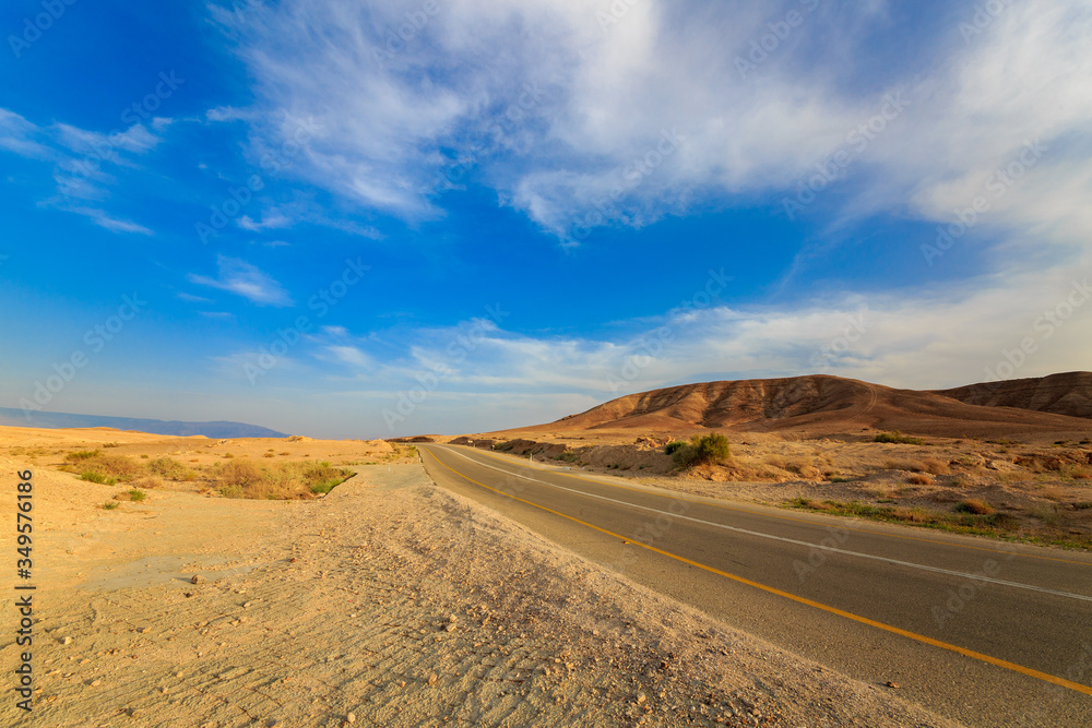 Empty road in a mountains at sunset