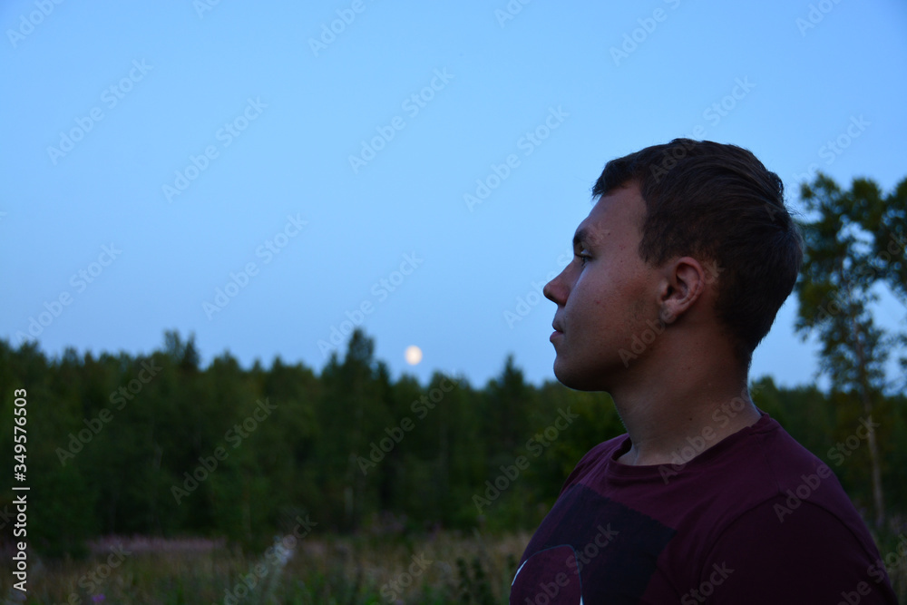 A teenager walks along the street and enjoys the beauty of the surrounding world. A teenager walks along the street and enjoys the beauty of the surrounding world.