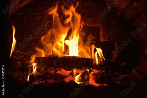 The fire in the Russian stove is burning brightly  creating comfort in the village house