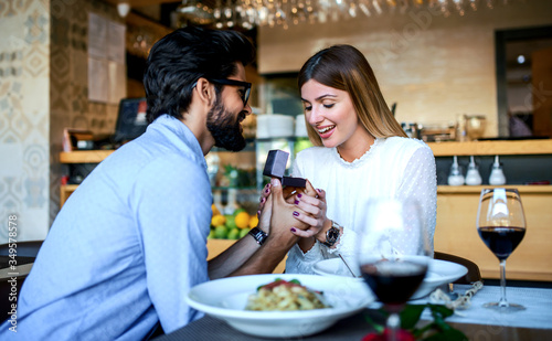 Young man surprised his girlfriend with engagement ring in the restaurant. Lifestyle  love  relationships  food concept