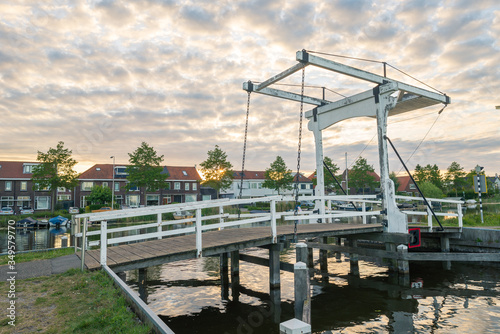 Traditional dutch drawbridge in the village of Reeuwijk-dorp, close to Gouda, Netherlands © Menyhert