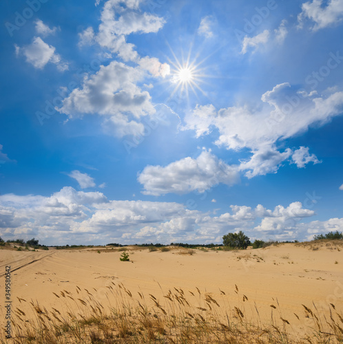 sandy prairie under a cloudy sky and hot sparkle sun