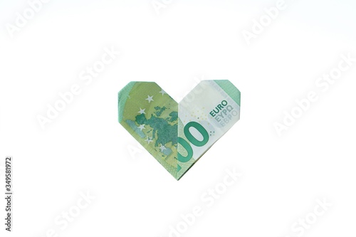 Isolated green hundred euro banknote formed to a heart. 100 Euro bill Origami heart. Cash money and white backgound with copy space. photo