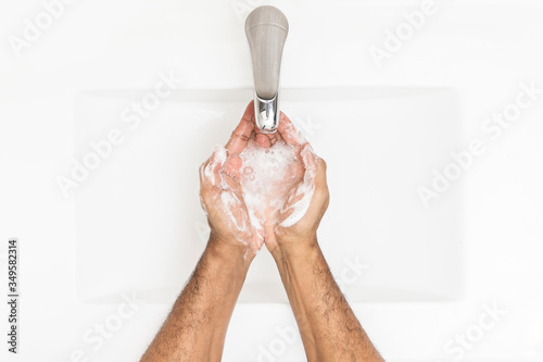 Washing hands with soap in the sink