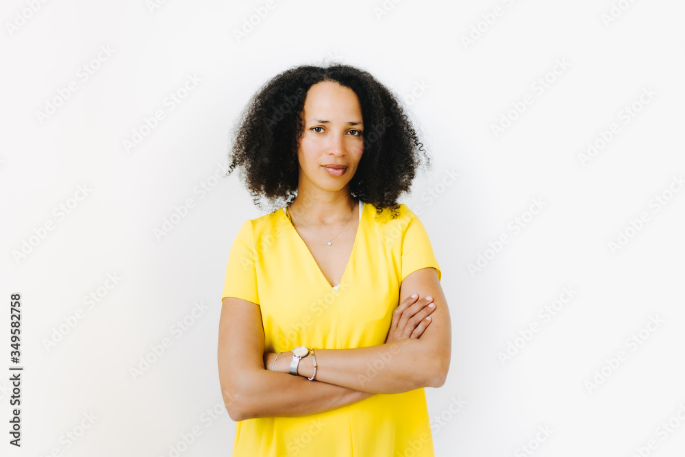 Portrait of serious looking black woman in yellow shirt Portrait of serious looking black woman in yellow shirt