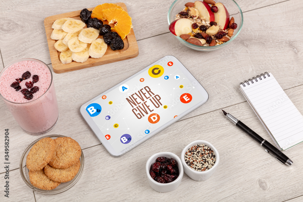 Healthy Tablet Pc compostion with NEVER GIVE UP inscription, weight loss concept Healthy Tablet Pc compostion with NEVER GIVE UP inscription, weight loss concept