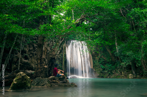 Tourist is sightseeing at Erawan Waterfall in Kanchanaburi in Thailand.