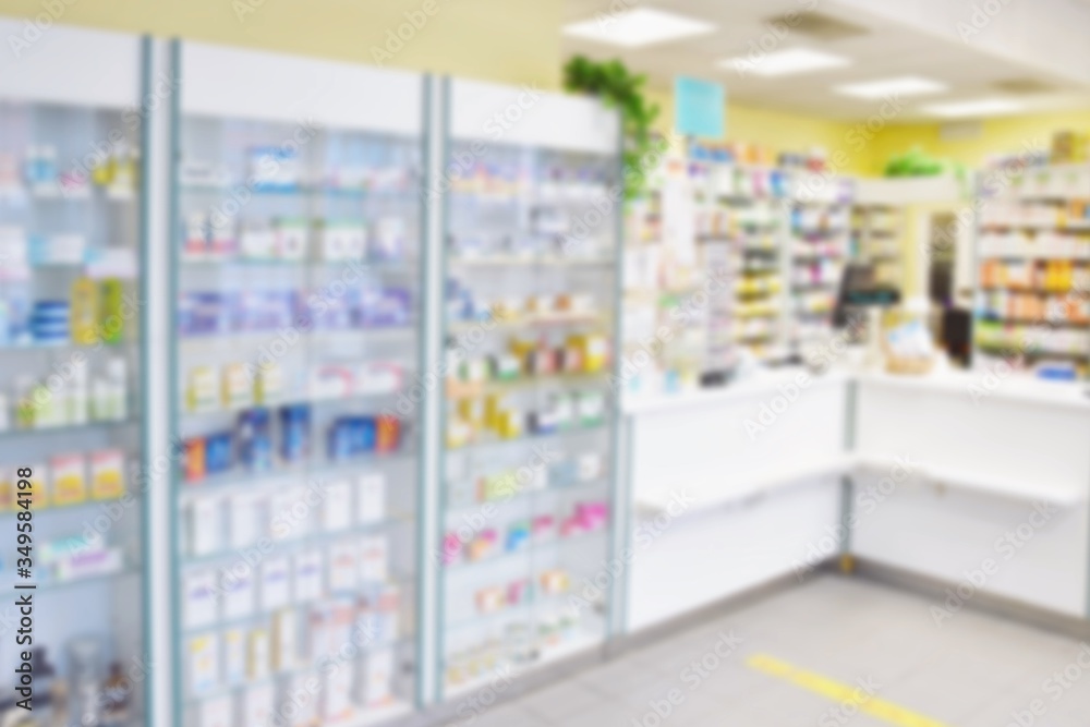 Blurred background. Interior of a pharmacy with goods and showcases. Medicines and vitamins for health. Concept for medicine and health - Coronavirus - COVID 19.
