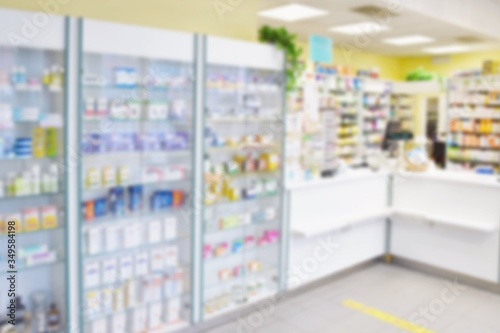 Blurred background. Interior of a pharmacy with goods and showcases. Medicines and vitamins for health. Concept for medicine and health - Coronavirus - COVID 19.