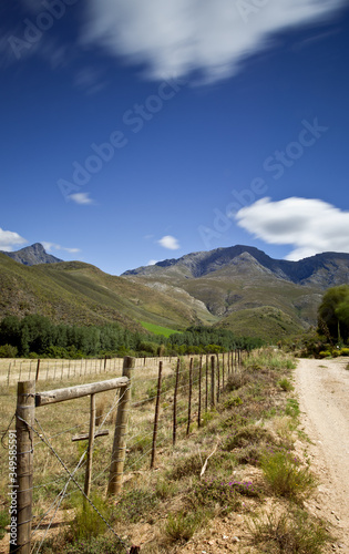 rural dirt road with mountains in background