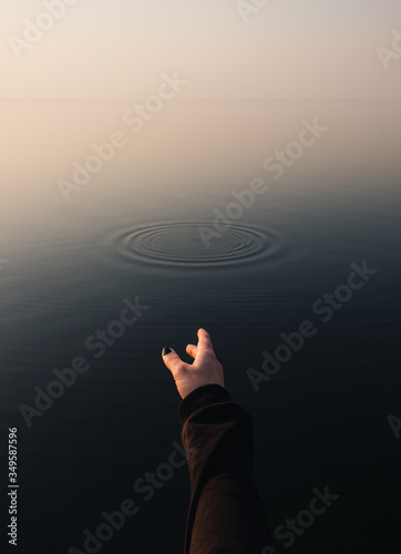 hands and ripples in water