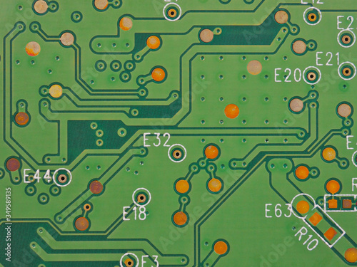 Green printed circuit board PCB hard drive. Fragment of printed wiring board PWB close up. Conductive pattern. IT&C. Background or wallpaper for theme computer hardware and equipment. Strong macro