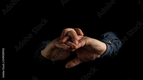men's hands interlace and stretch their fingers. on a black background