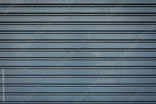 Metal shutters roll up door texture background.