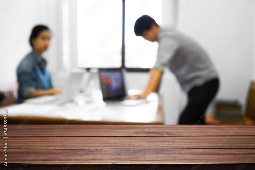Empty wooden desk space over blurred office or meeting room background. Product display montage. Empty wooden desk space over blurred office or meeting room background. Product display montage.