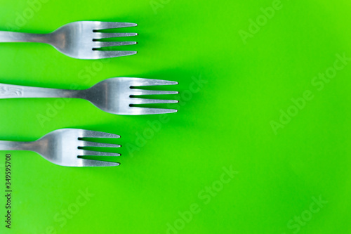 cutlery on green background flat lay