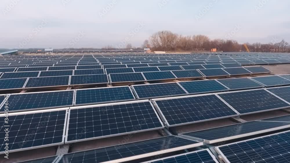 Modern solar power station on roof. Photovoltaic panels generate clean energy from the evening sun. Sustainable ecological energy. Camera moves back. Modern solar power station on roof. Photovoltaic panels generate clean energy from the evening sun. Sustainable ecological energy. Camera moves back.
