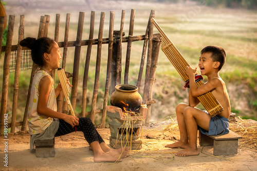 Rural children playing with blowing music and laughter. People Thailand.