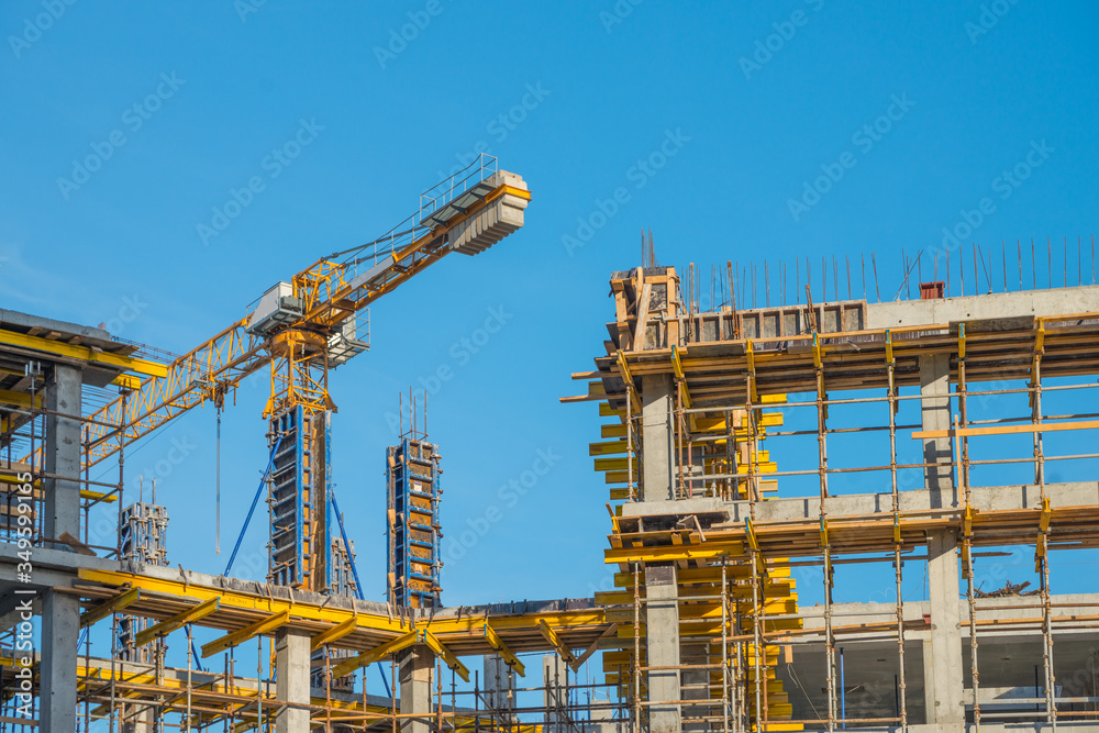 Construction crane near new built house. Construction and developing horizontal photo Construction crane near new built house. Construction and developing horizontal photo