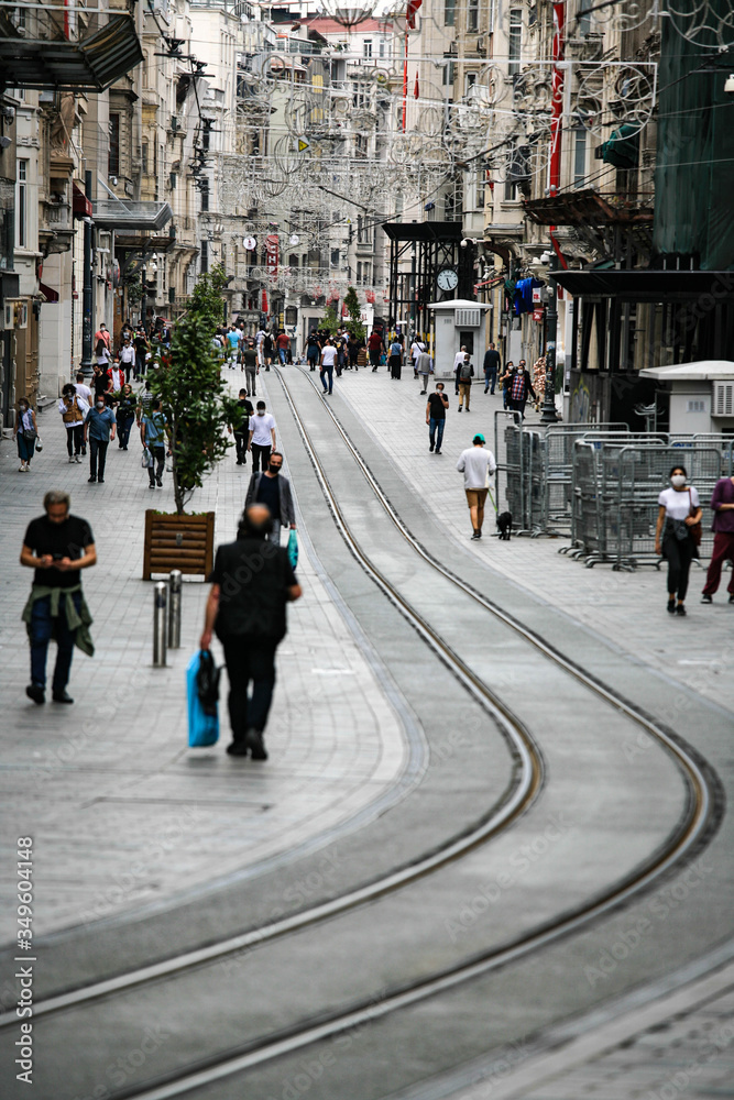 People walking down the street. Tram rails. Corona days in Istanbul