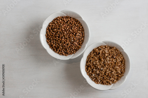 Buckwheat in a white bowl, different types, on a white table