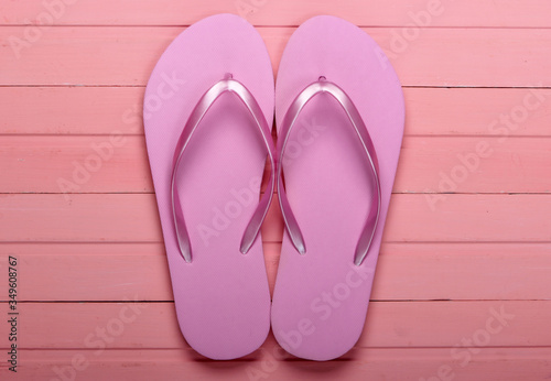Flip Flops on a pink wooden background. Top view