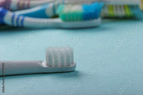 New and old used toothbrushes on a blue background close-up. Oral Care