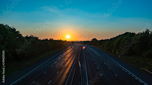 Sun setting over a empty motorway (M40) with reduced traffic due to COVID-19 
