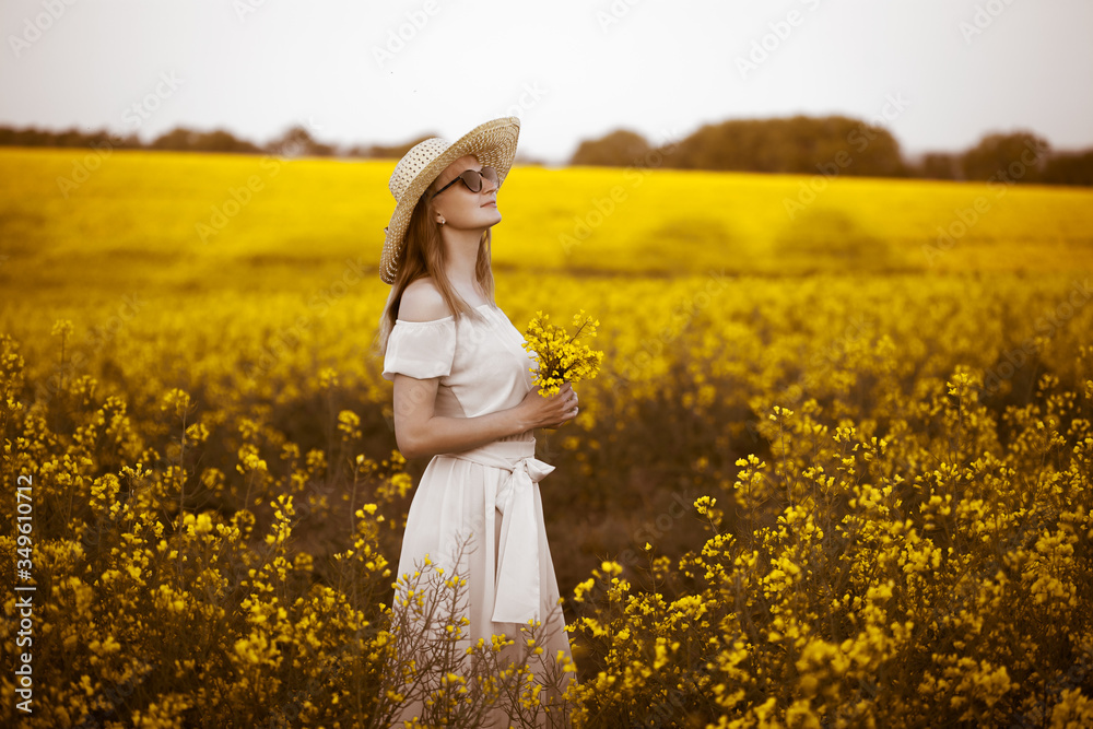 Young woman standingon the rape with sunrise on the background Young woman standingon the rape with sunrise on the background