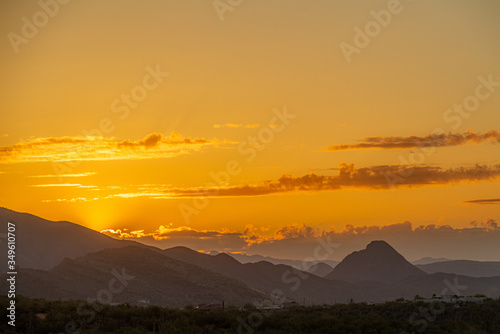 The sun setting behind mountains in the Sonoran Desert of Arizona. © Jason Yoder