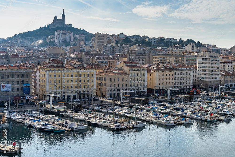 Scenic Marseille cityscape with Notre Dame del Garde basilica behind the Old Port, France