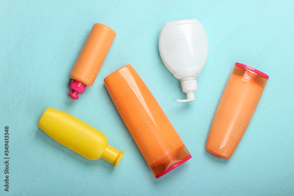 Shampoo bottles on blue background. Skin and hair care. Hygiene and cosmetics. Beauty flat lay. Top view Shampoo bottles on blue background. Skin and hair care. Hygiene and cosmetics. Beauty flat lay. Top view