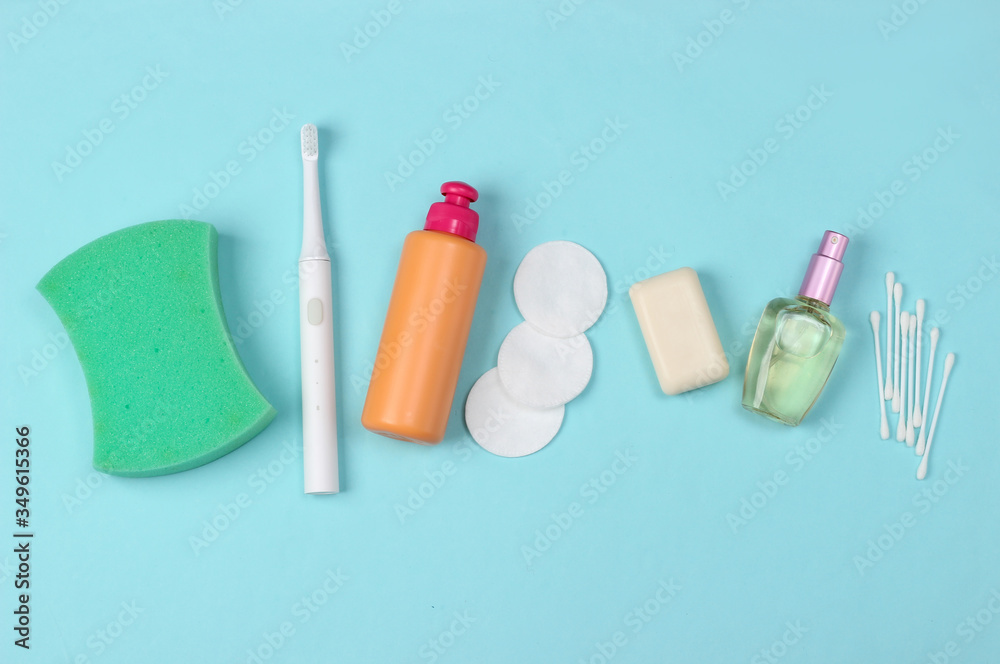 Fototapeta premium Beauty, health care, cosmetics, hygiene product on blue background. Flat lay. Top view